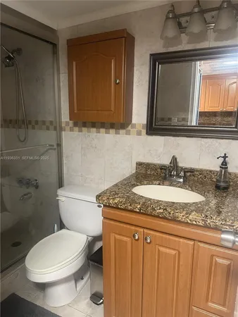 a bathroom with a toilet a sink and shower