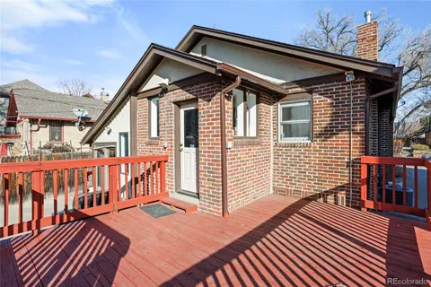 a front view of a house with wooden deck