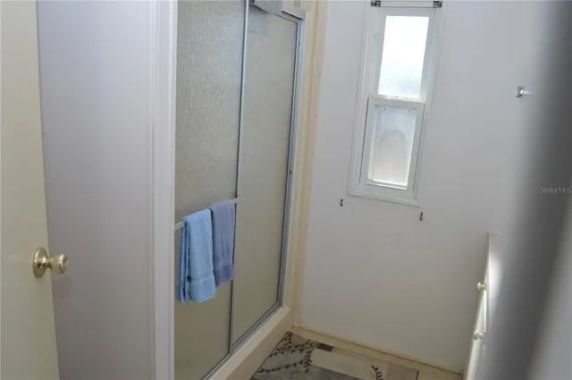 a bedroom with a bed and a wooden door