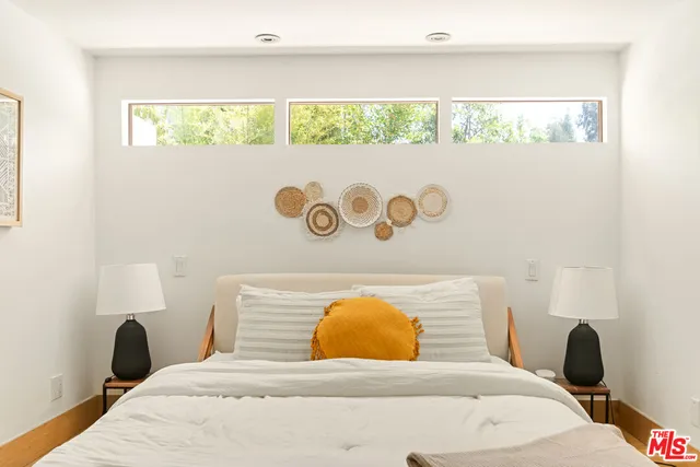 a bedroom with a bed and a table in it