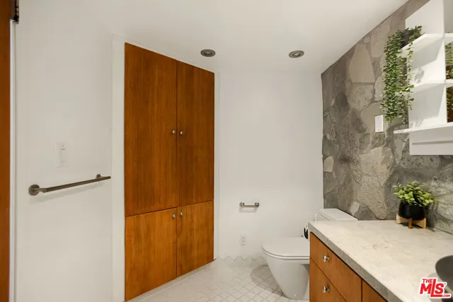 a view of a white house with a yard and a garden