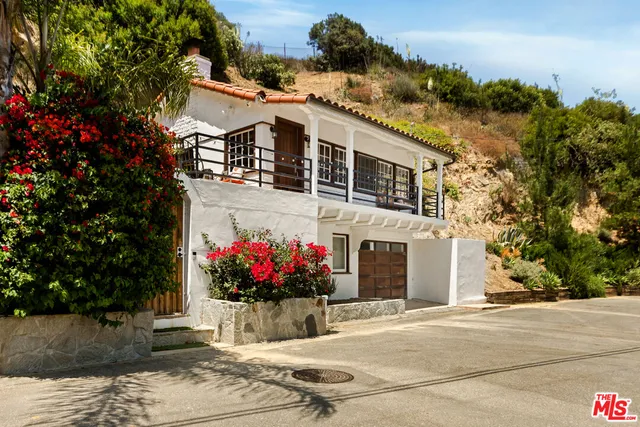 a view of a white house with large windows