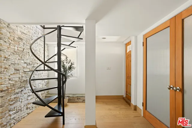 a living room with furniture a rug and white walls