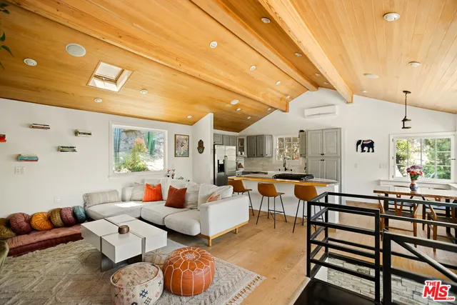 a living room with furniture a fireplace and windows