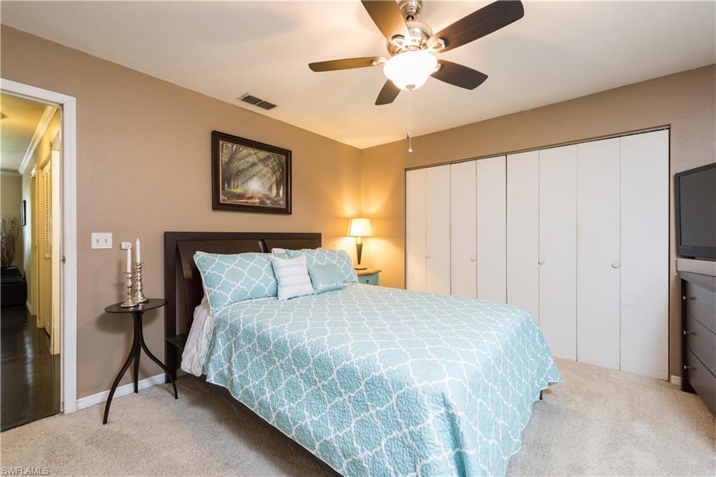 17401 Butler Road Fort Myers, FL 33967 - Photo 16 of 22 a bedroom with a large bed and a chandelier
