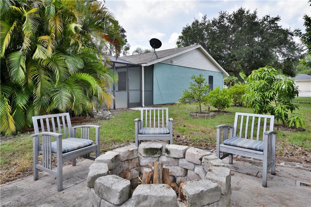 17401 Butler Road Fort Myers, FL 33967 - Photo 22 of 22 a view of a chair and table in backyard of the house