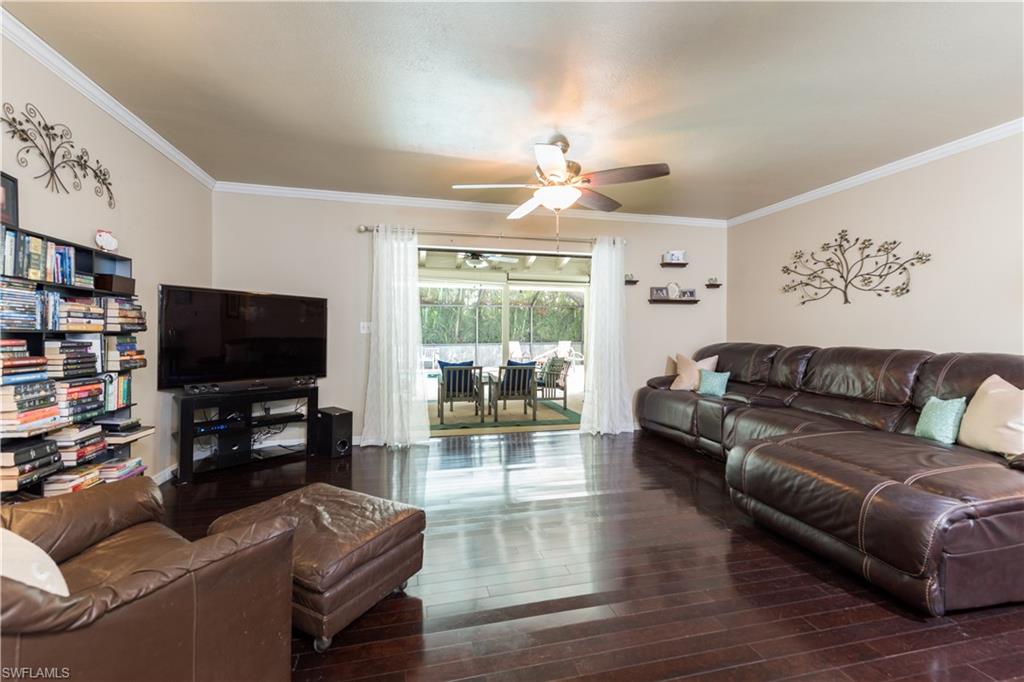 17401 Butler Road Fort Myers, FL 33967 - Photo 4 of 22 a living room with furniture and a flat screen tv