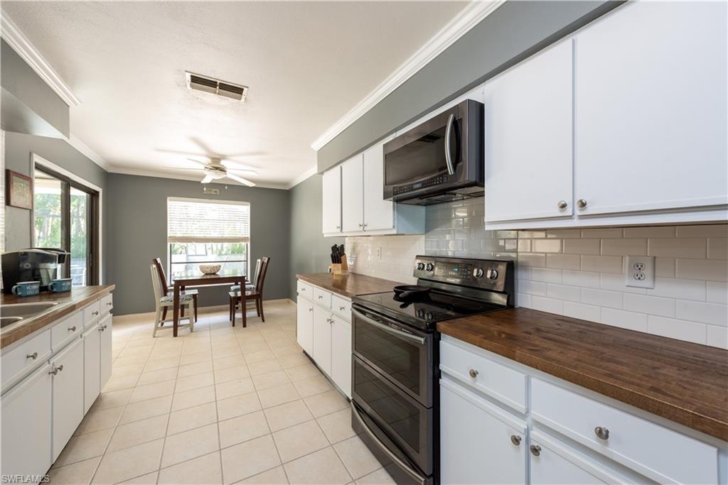 17401 Butler Road Fort Myers, FL 33967 - Photo 8 of 22 a kitchen with stainless steel appliances granite countertop a stove a sink and a microwave