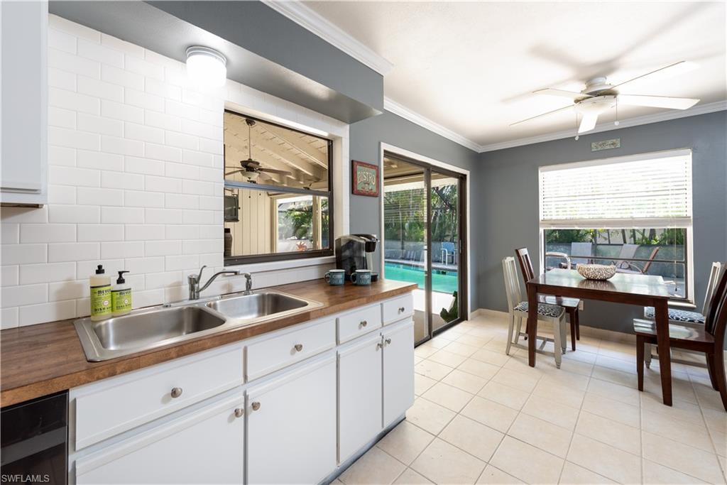 17401 Butler Road Fort Myers, FL 33967 - Photo 9 of 22 a kitchen with a sink and chairs
