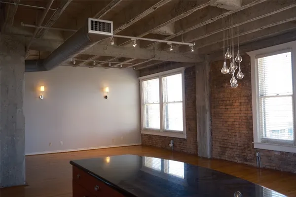 a view of a room with wooden floor