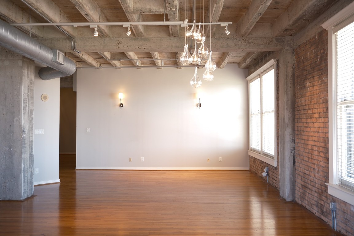 201 Main Street, Unit 6G Houston, TX 77002 - Photo 4 of 14 Ambient lighting throughout casts a soft, moody glow, layering warmth and depth into every space. Thoughtfully placed fixtures complement the home’s industrial character, bringing a cohesive feel throughout.