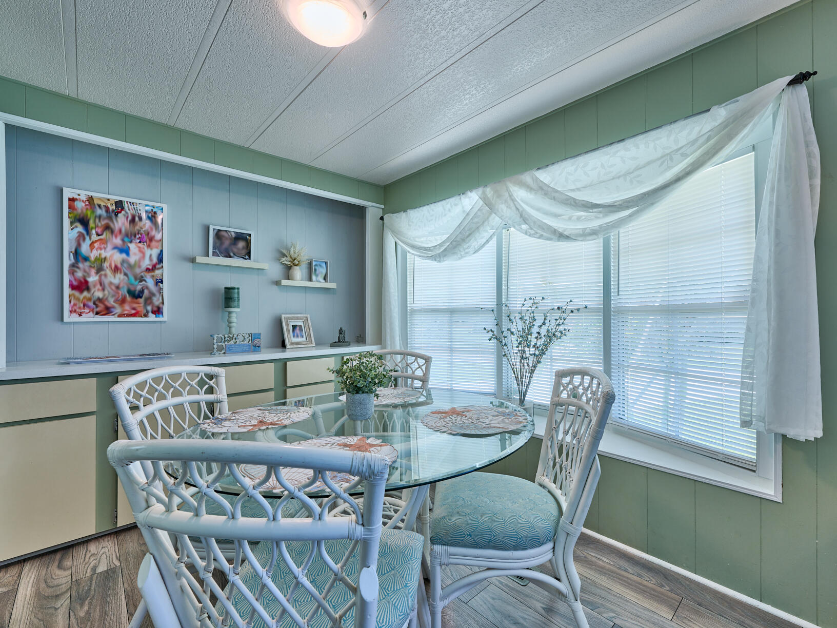 6977 Southeast Delegate Street Hobe Sound, FL 33455 - Photo 20 of 60 a view of a dining room with furniture window and wooden floor
