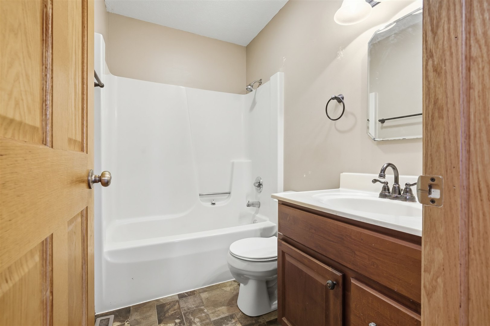 409 East Delaware Street Dwight, IL 60420 - Photo 14 of 31 a bathroom with a sink toilet vanity and tub