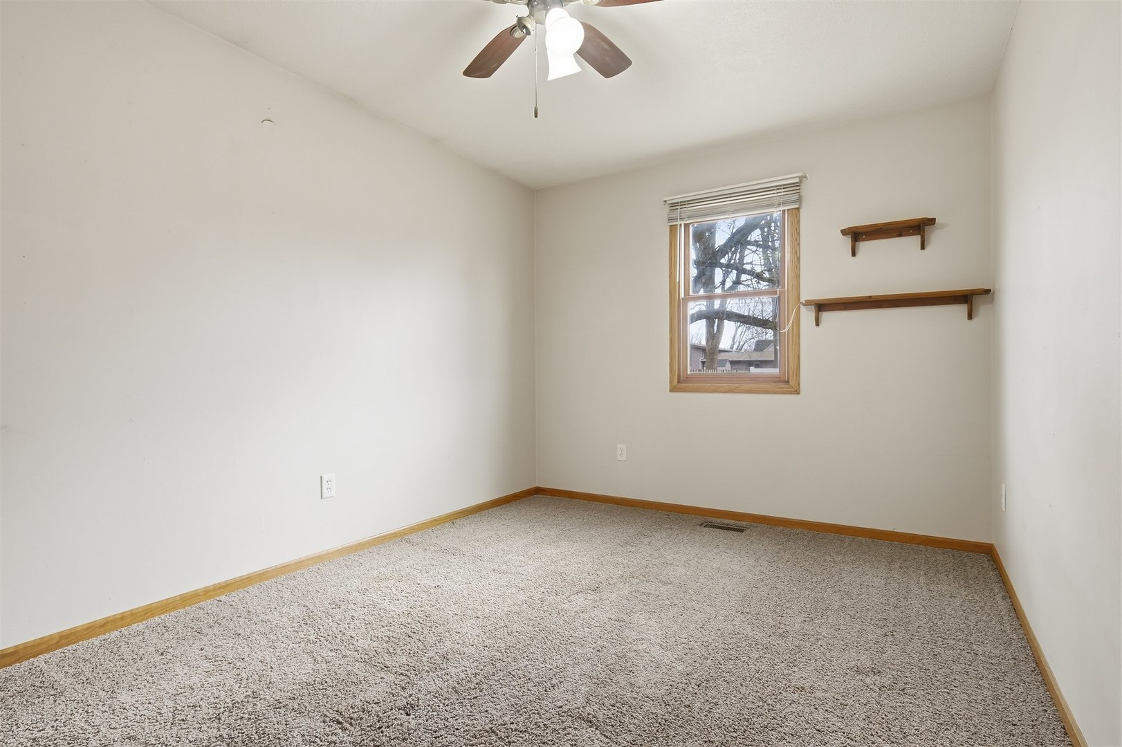 409 East Delaware Street Dwight, IL 60420 - Photo 19 of 31 an empty room with a window and a ceiling fan