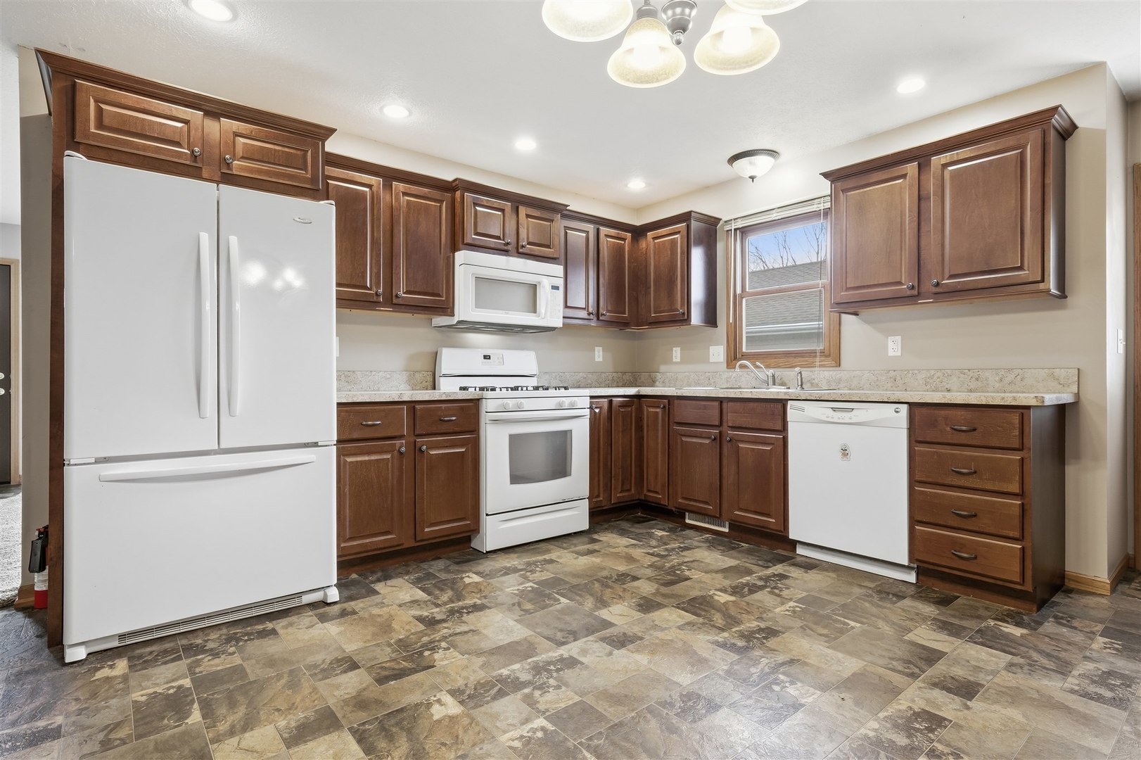 409 East Delaware Street Dwight, IL 60420 - Photo 8 of 31 a kitchen with a stove a sink and a refrigerator