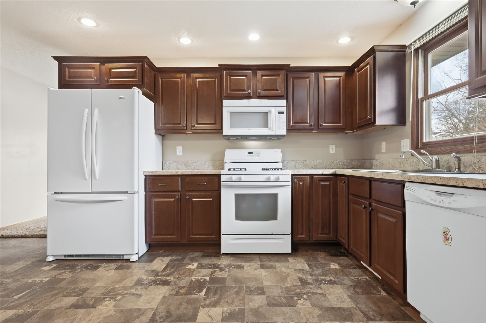 409 East Delaware Street Dwight, IL 60420 - Photo 9 of 31 a kitchen with a refrigerator stove top oven and sink