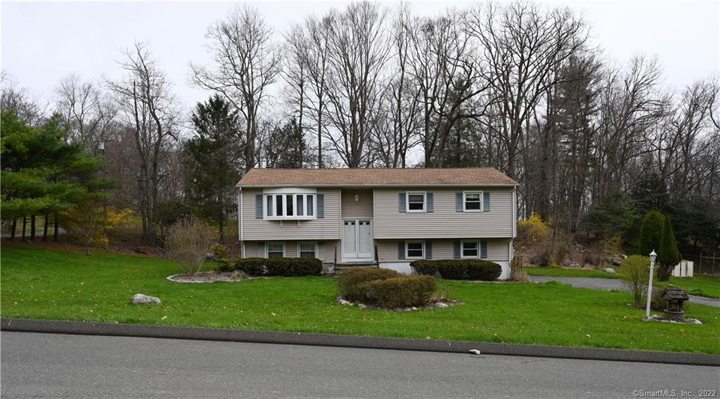 9 Oak Ridge Road Bethel, CT 06801 - Photo 1 of 1 a front view of a house with a garden and trees
