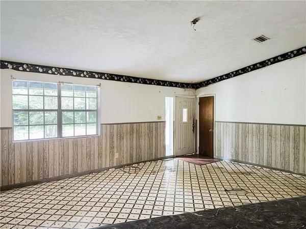 a view of a bedroom with wooden floor