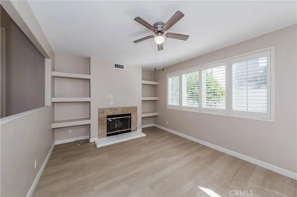 a view of a livingroom with a ceiling fan and a window