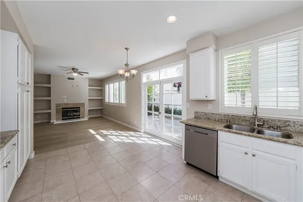 a large kitchen with granite countertop a stove sink and cabinets