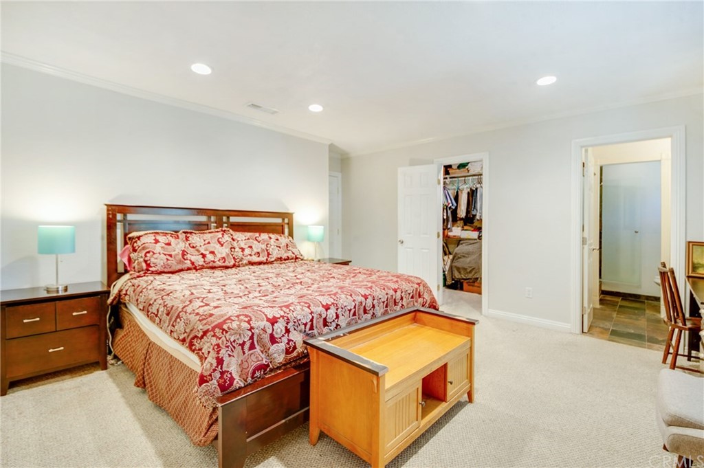 513 D Street, Unit 53 Upland, CA 91786 - Photo 13 of 25 a bedroom with a bed and a flat tv screen on dresser