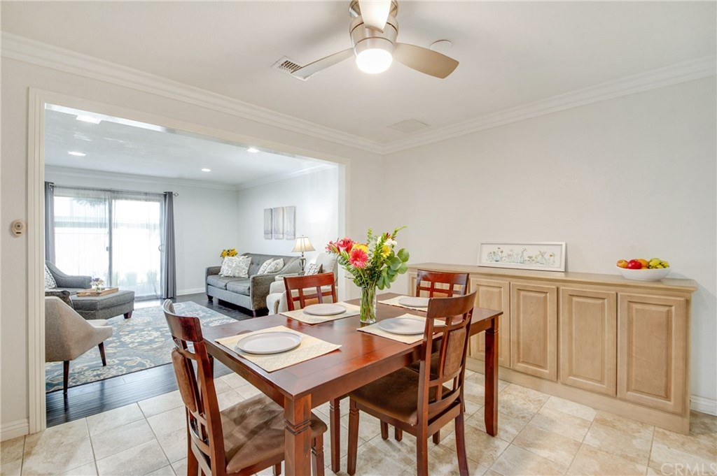 513 D Street, Unit 53 Upland, CA 91786 - Photo 6 of 25 a view of a dining room with furniture and a chandelier