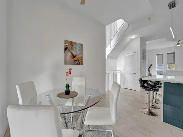 a dining room with furniture and wooden floor