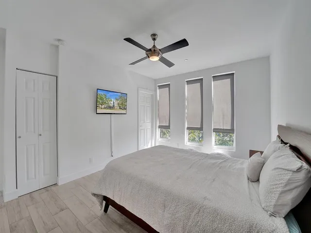 a bedroom with a large bed and a large window