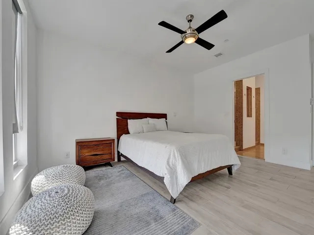 a bedroom with a bed rug and window