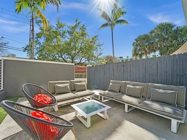 a backyard of a house with table and chairs