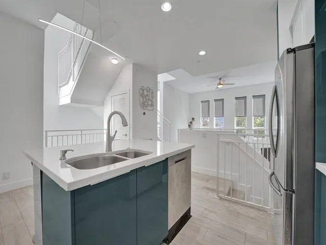 a kitchen with granite countertop a sink and cabinets