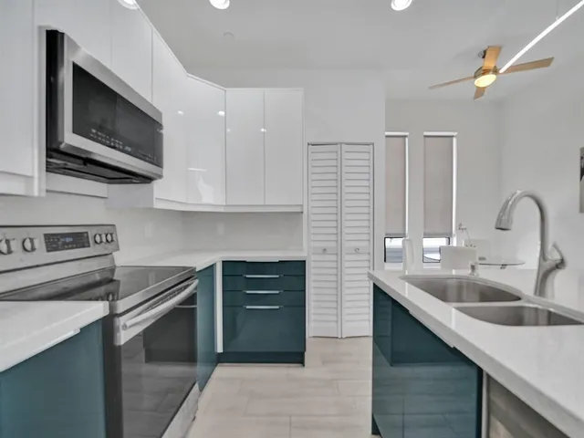 a kitchen with stainless steel appliances granite countertop a sink and stove top oven