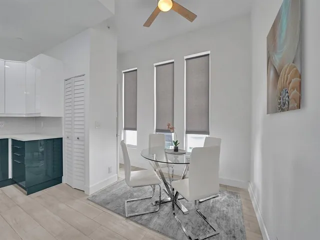 a view of a livingroom with furniture and chandelier fan
