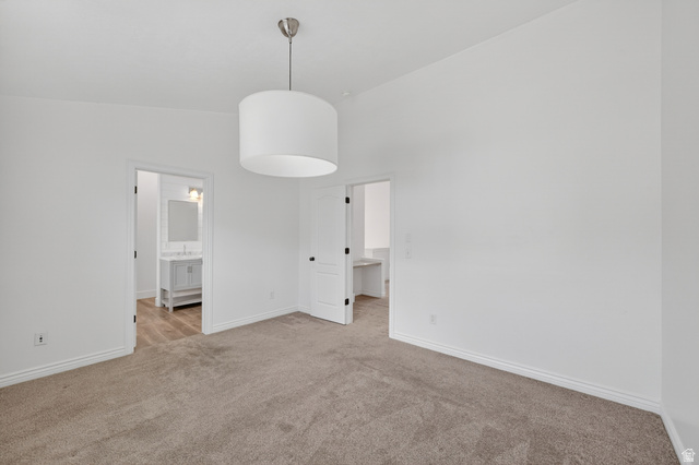 14771 Haddington Road Draper, UT 84020 - Photo 19 of 44 Spacious room with plush carpeting, crisp white walls, and a contemporary drum pendant light fixture