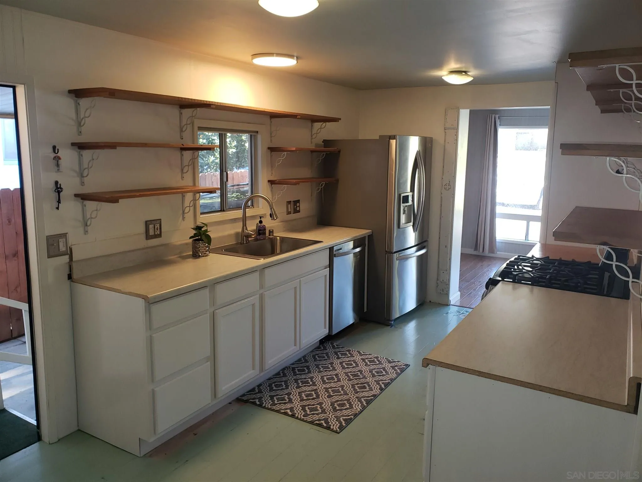 3909 Reche Road, Unit 151 Fallbrook, CA 92028 - Photo 7 of 24 a kitchen with stainless steel appliances granite countertop a refrigerator and a stove