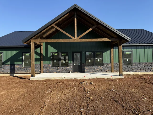 a patio with a table and chairs and potted plants