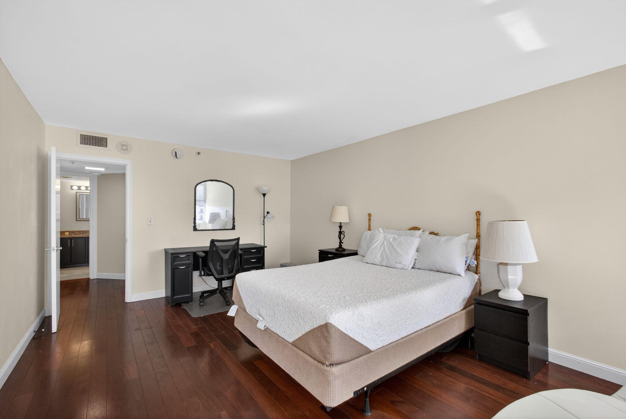 5200 North Ocean Drive, Unit 1004 Singer Island, FL 33404 - Photo 5 of 26 a bedroom with a bed and wooden floor