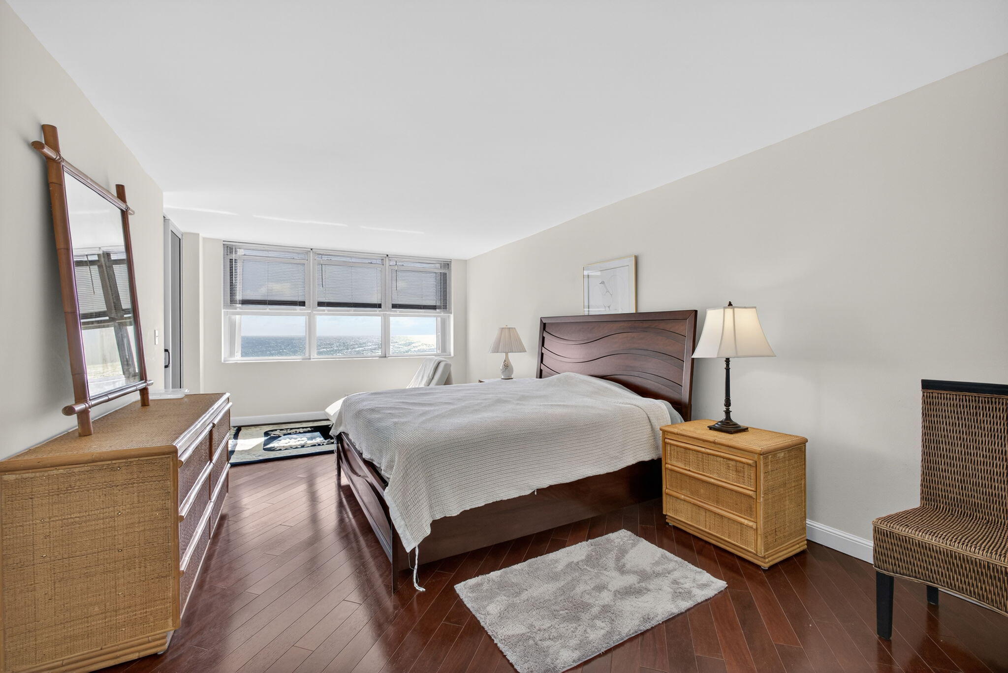 5200 North Ocean Drive, Unit 1004 Singer Island, FL 33404 - Photo 8 of 26 a bedroom with a bed and wooden floor