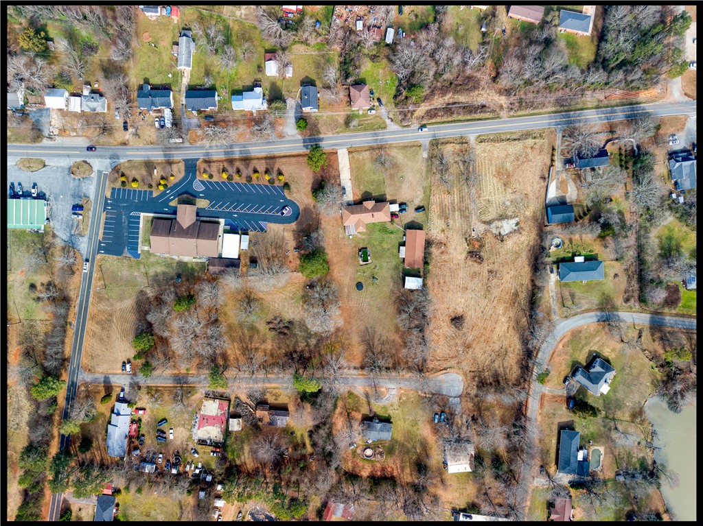 2205 Whitehall Road Anderson, SC 29625 - Photo 11 of 13 An aerial view captures the vast expanse of land and properties, showcasing the surrounding natural beauty.