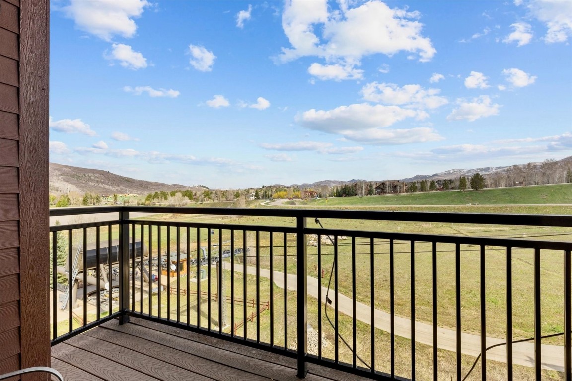 1175 Bangtail Way, Unit 5118 Steamboat Springs, CO 80487 - Photo 18 of 46 a view of balcony with wooden floor & fence