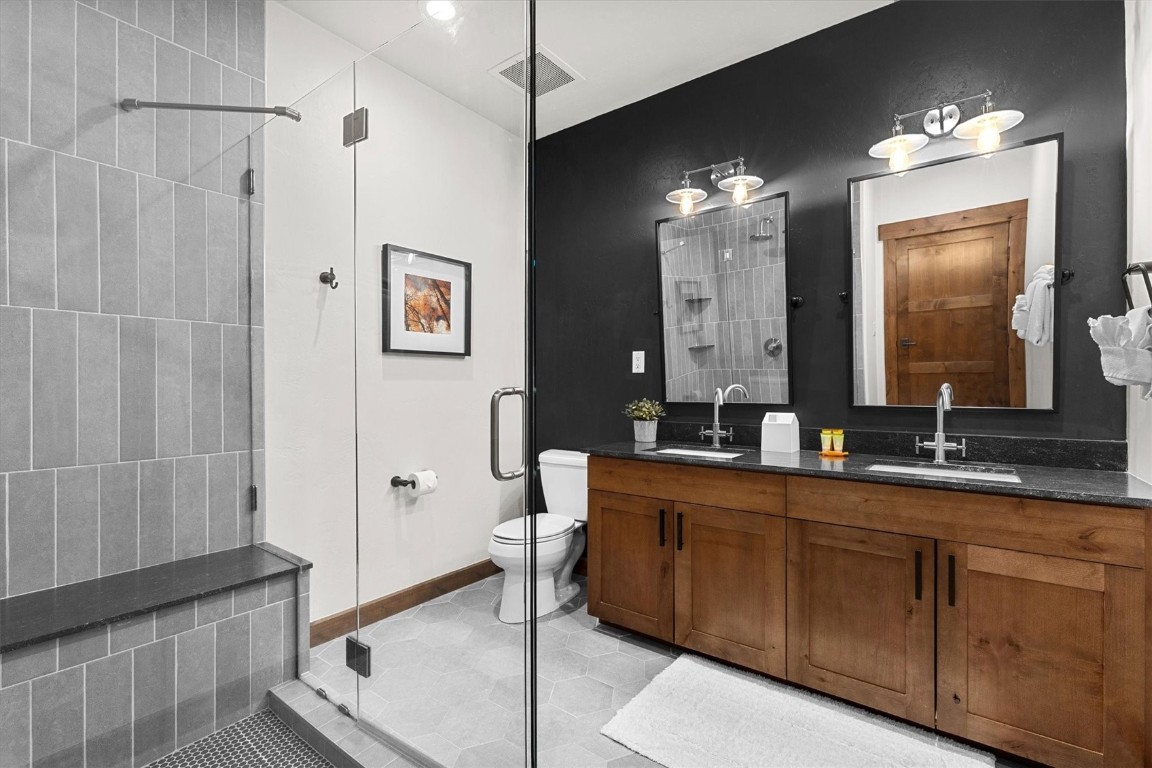 1175 Bangtail Way, Unit 5118 Steamboat Springs, CO 80487 - Photo 25 of 46 a bathroom with a double vanity sink a mirror and a shower