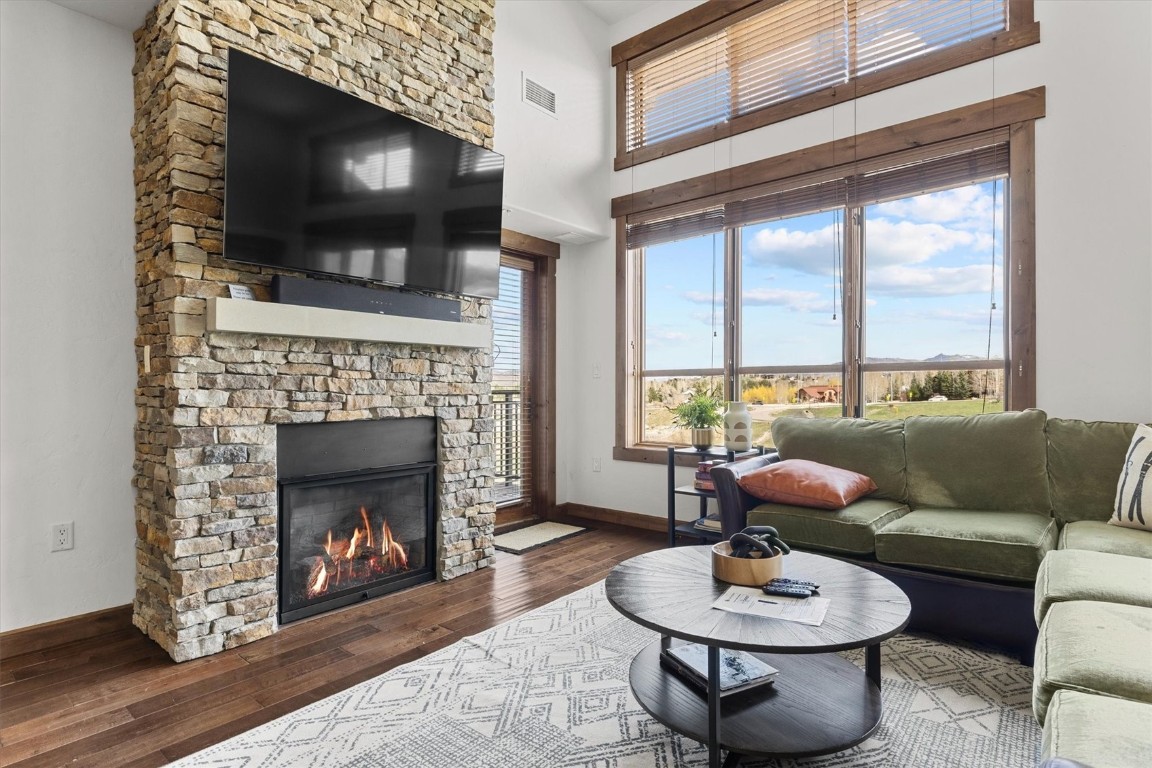 1175 Bangtail Way, Unit 5118 Steamboat Springs, CO 80487 - Photo 3 of 46 a living room with furniture a flat screen tv and a fireplace