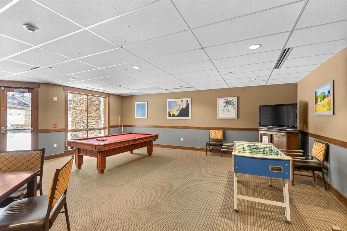 1175 Bangtail Way, Unit 5118 Steamboat Springs, CO 80487 - Photo 40 of 46 a living room with furniture a flat screen tv and a table