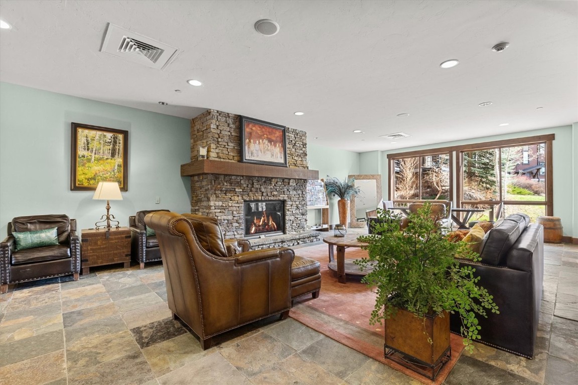 1175 Bangtail Way, Unit 5118 Steamboat Springs, CO 80487 - Photo 43 of 46 a living room with furniture potted plant and a fireplace