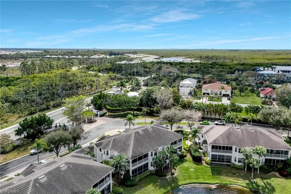 an aerial view of multiple houses with a yard