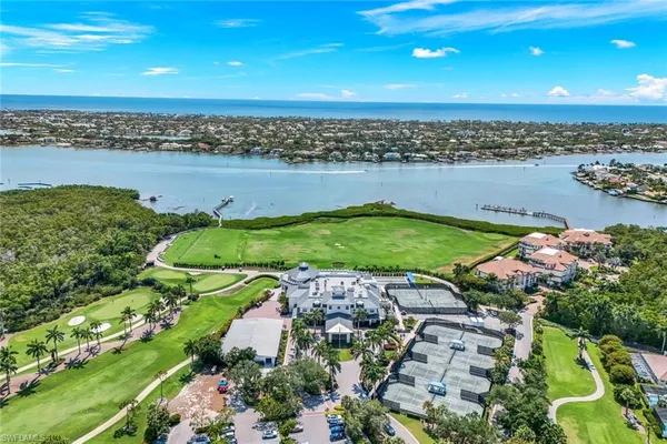 an aerial view of a city with lots of residential buildings lake and ocean view