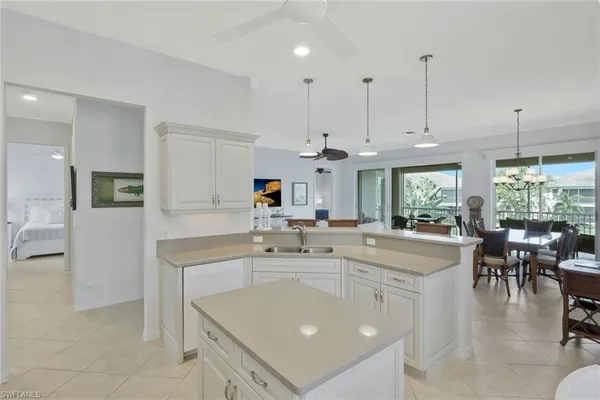 a kitchen with stainless steel appliances granite countertop a sink a stove and a refrigerator