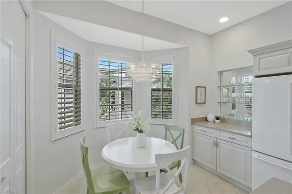 a kitchen with a stove a sink a dining table and chairs