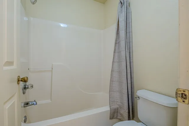 a bathroom with a shower and a toilet