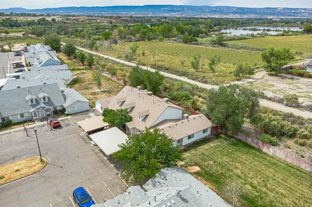 an aerial view of residential houses with outdoor space